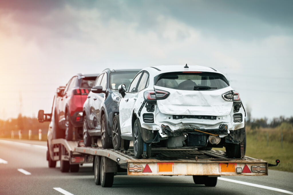 Damaged cars loaded onto a tow truck