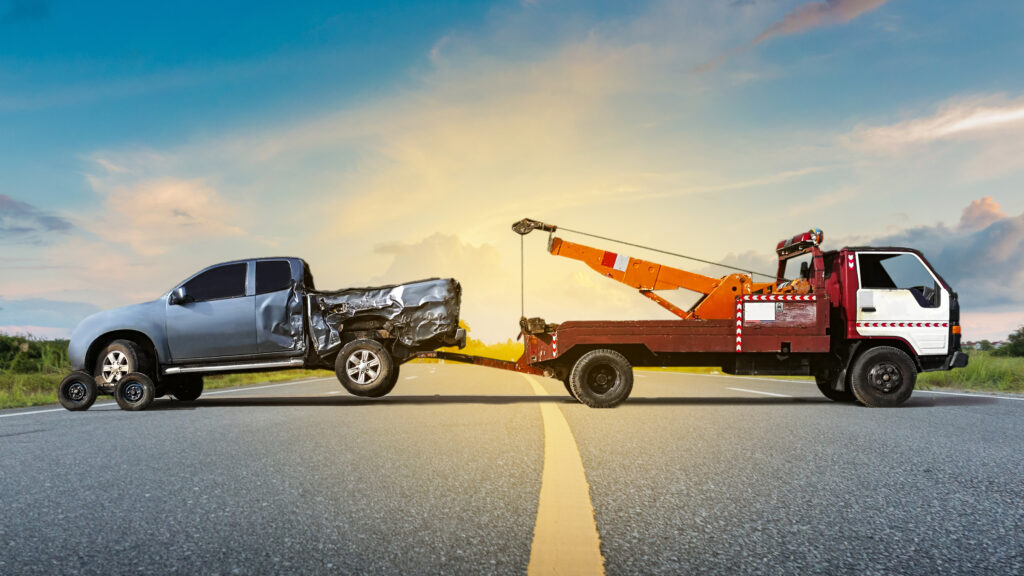 A damaged pickup being loaded for towing